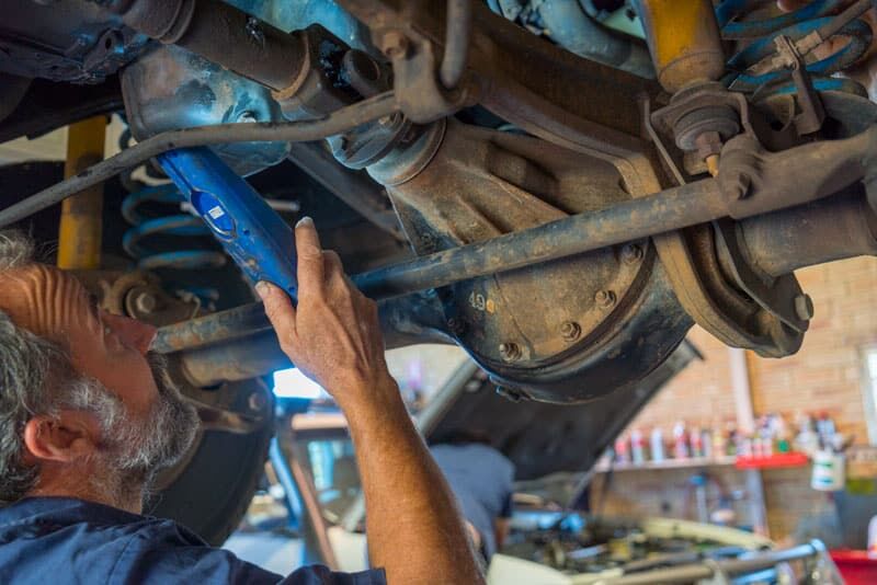 Armadale 4WD mechanic working in the engine bay of a 4WD
